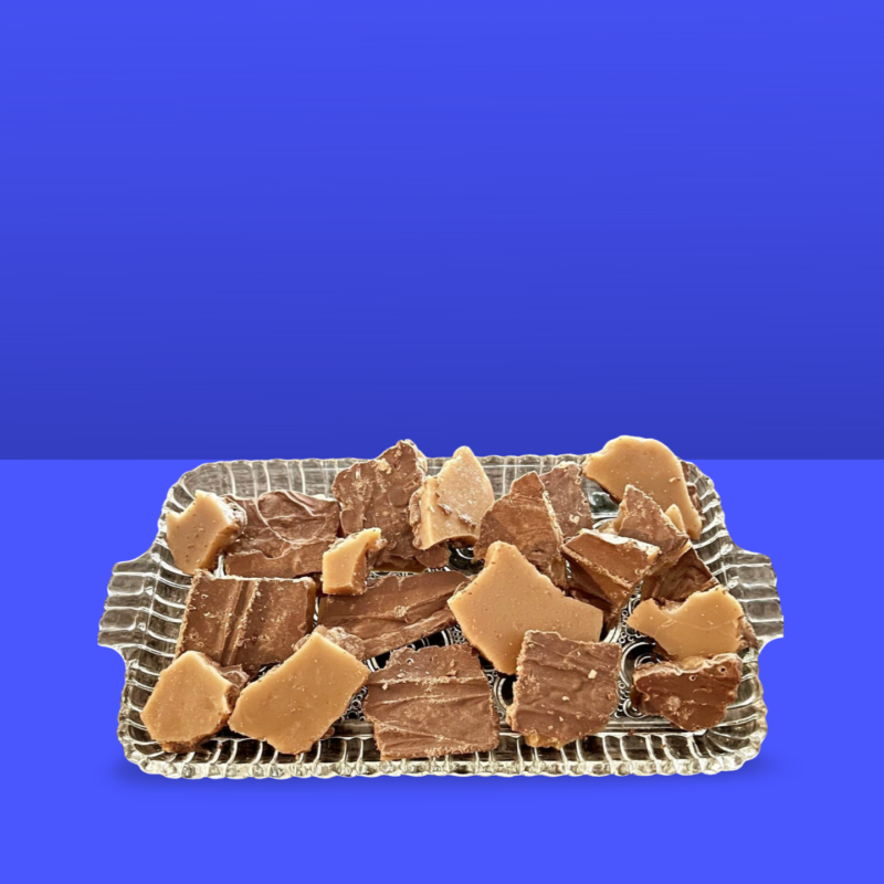 Toffee displayed on a crystal glass tray w blue background